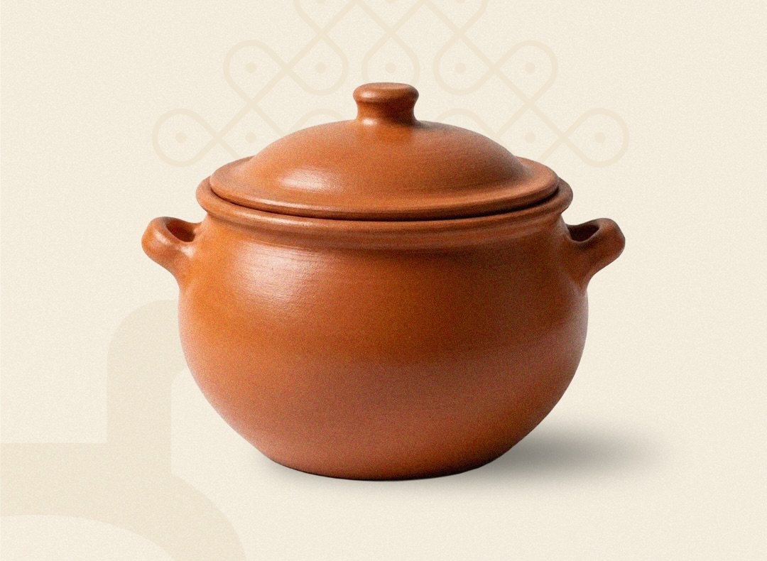 A lidded terracotta cooking pot